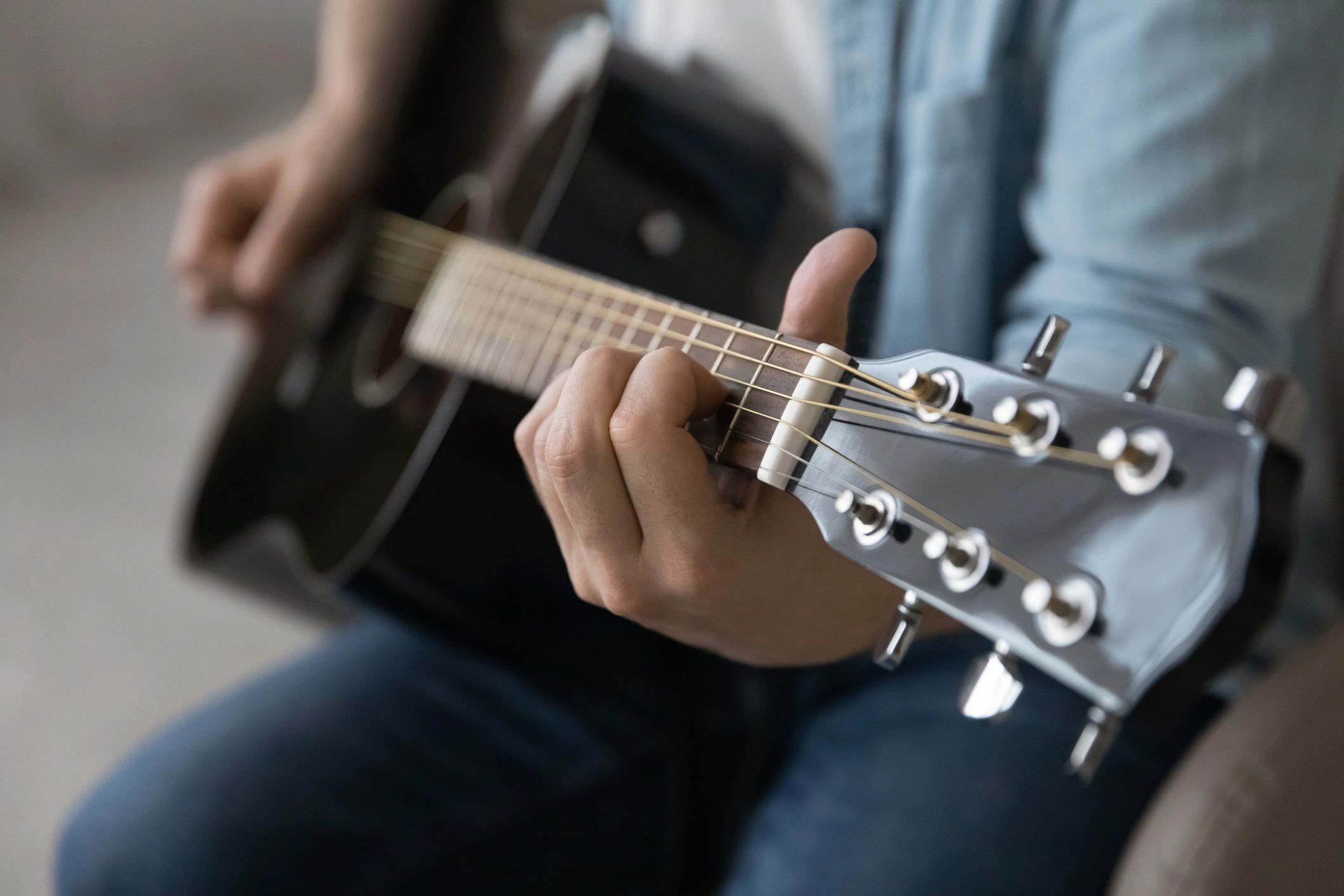 Musician playing acoustic guitar