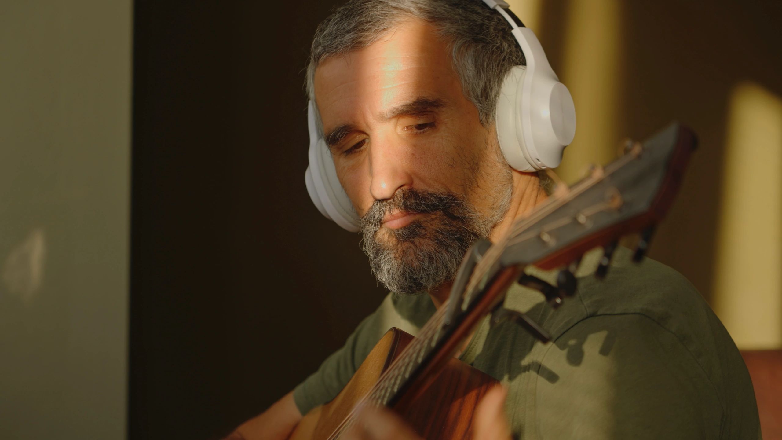 Musician playing guitar at sunrise